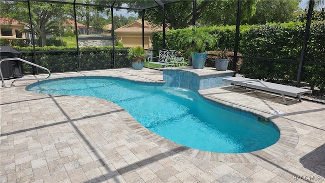 outdoor pool with a patio and glass enclosure