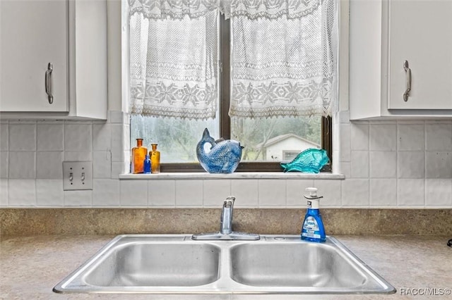 interior details with sink and tasteful backsplash