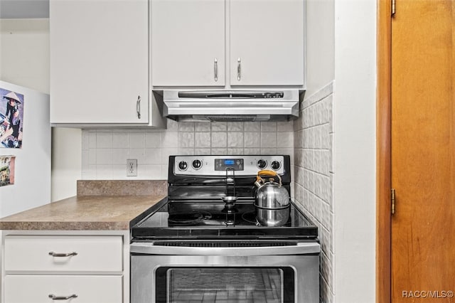 kitchen with decorative backsplash, ventilation hood, stainless steel electric stove, and white cabinets