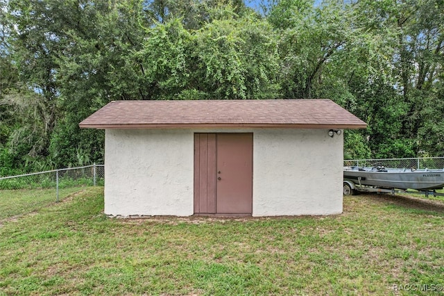 view of outbuilding with a lawn