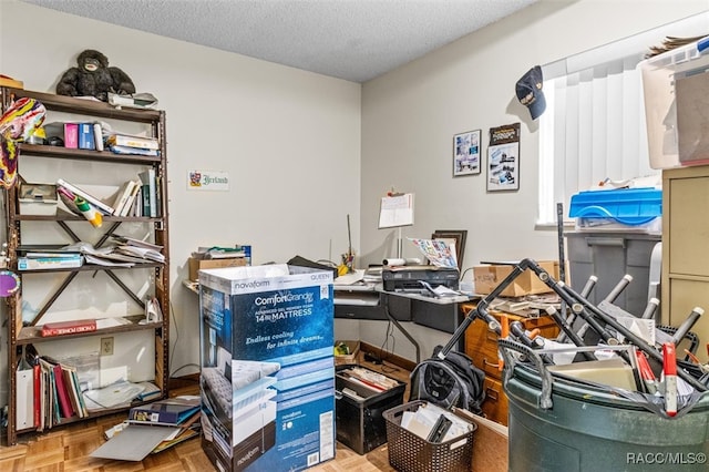 home office featuring a textured ceiling and parquet floors