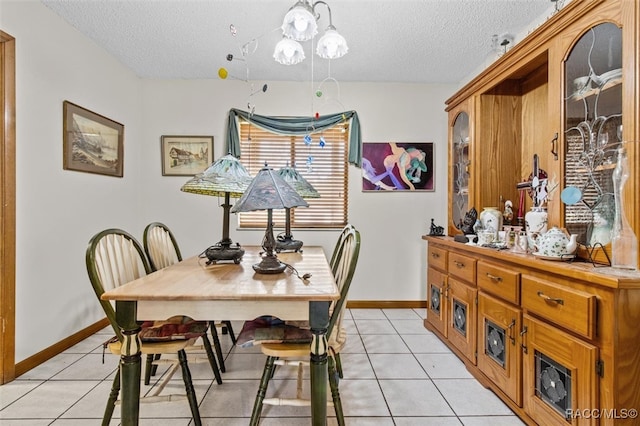 dining room with light tile patterned flooring and a textured ceiling