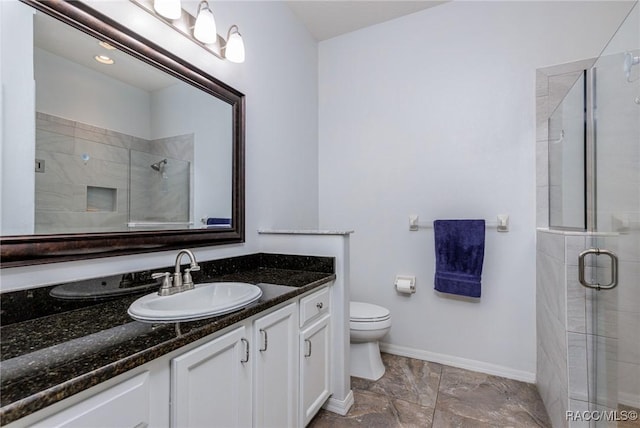 bathroom with vanity, toilet, and an enclosed shower