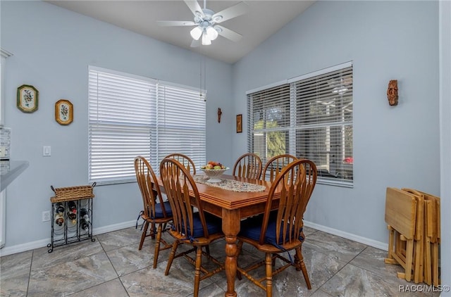 dining room featuring ceiling fan and lofted ceiling