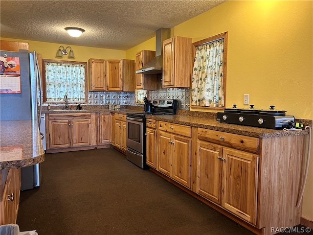 kitchen with tasteful backsplash, a textured ceiling, stainless steel appliances, sink, and dark colored carpet