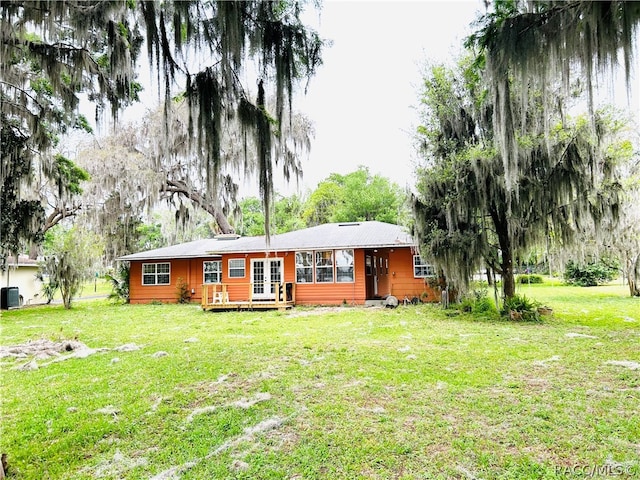 view of front of house with cooling unit and a front yard