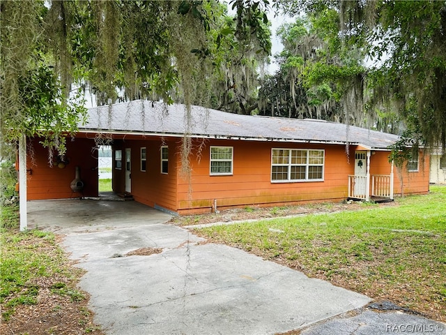 single story home featuring a carport