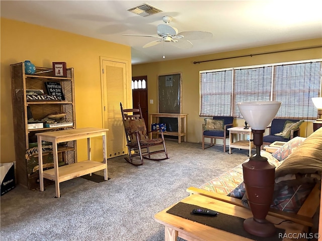 living room featuring carpet and ceiling fan