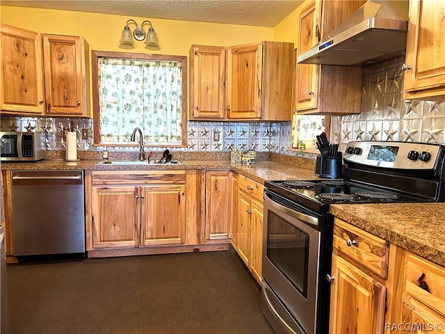 kitchen featuring sink, decorative backsplash, a textured ceiling, appliances with stainless steel finishes, and extractor fan