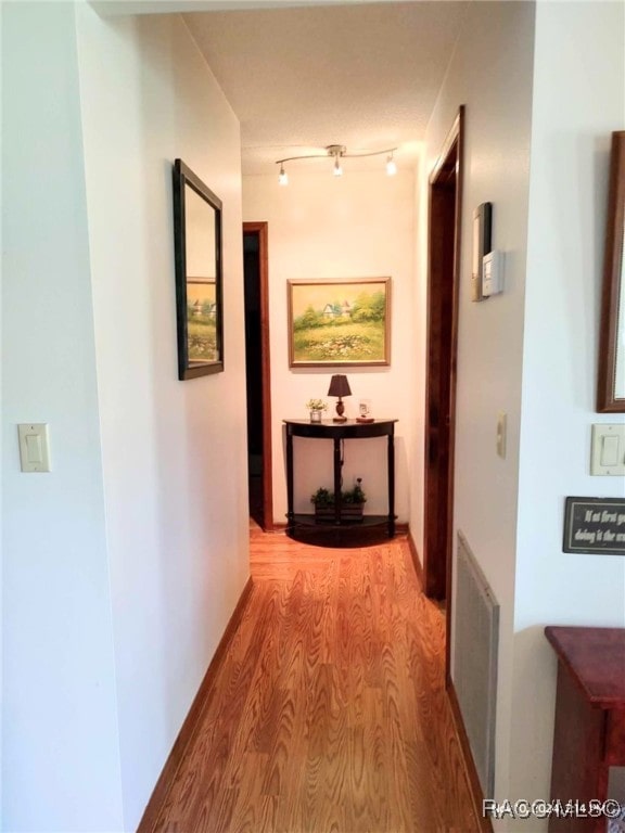 hall with light hardwood / wood-style floors