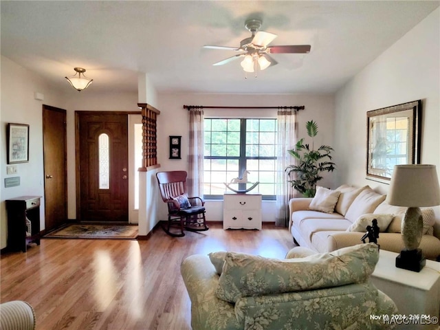 living room with ceiling fan and wood-type flooring