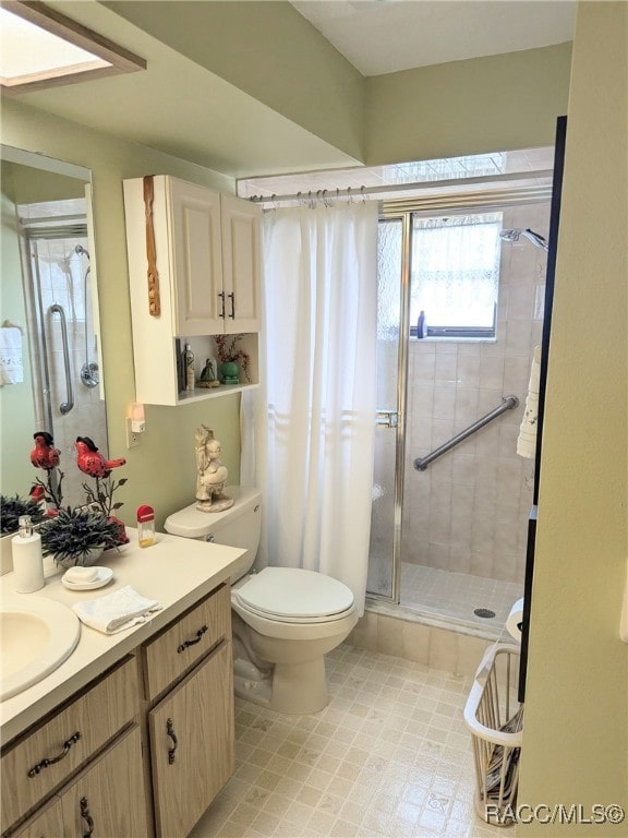 bathroom featuring vanity, an enclosed shower, and toilet