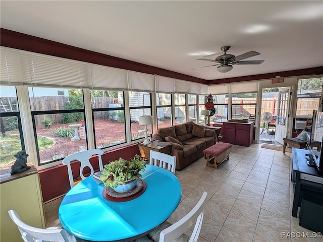 sunroom featuring ceiling fan