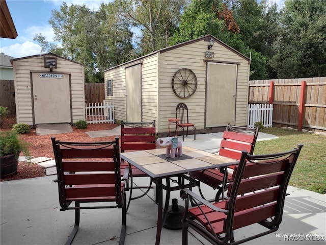 view of patio with a storage unit