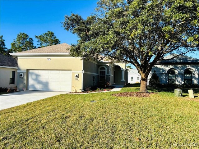 view of front of house with a garage and a front lawn