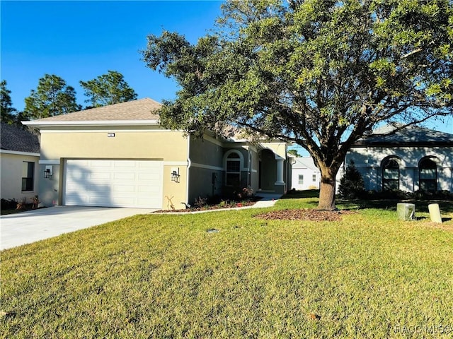 view of front of property with a garage and a front lawn