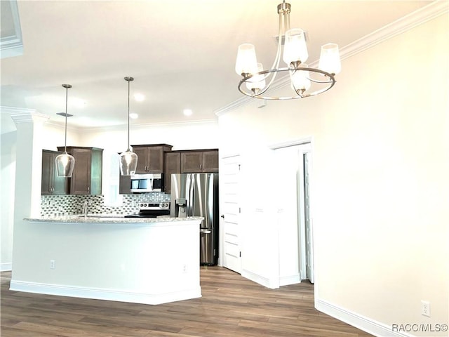 kitchen featuring stainless steel appliances, tasteful backsplash, dark brown cabinetry, and decorative light fixtures