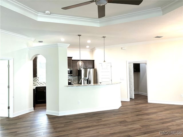 kitchen with tasteful backsplash, ornamental molding, dark hardwood / wood-style floors, and appliances with stainless steel finishes