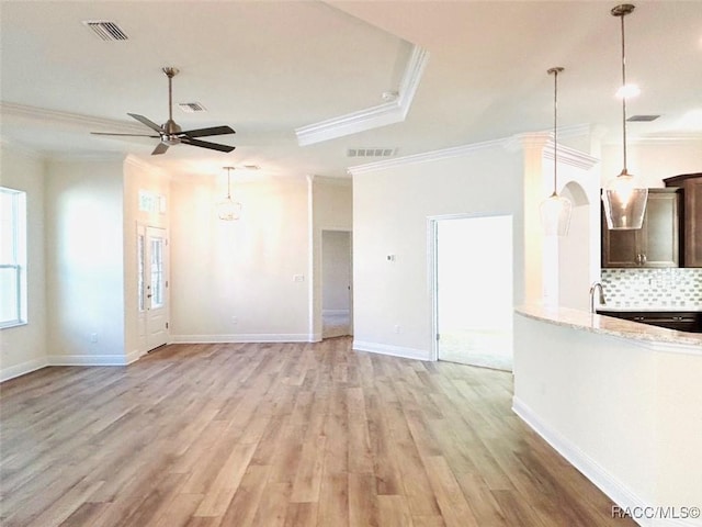 unfurnished living room with ceiling fan, ornamental molding, sink, and light hardwood / wood-style floors