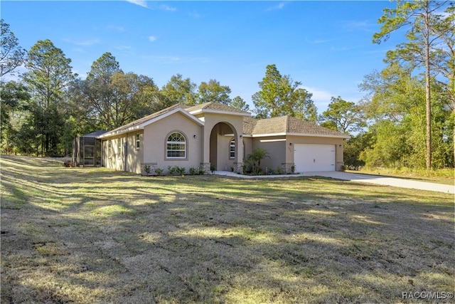 view of front facade with a front yard and a garage