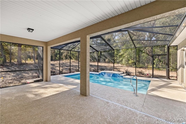 view of swimming pool with a lanai, pool water feature, and a patio area