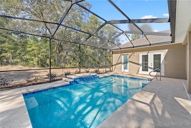 view of swimming pool featuring pool water feature, glass enclosure, a patio area, and french doors