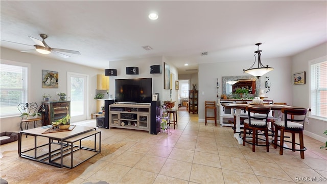 tiled living room featuring ceiling fan