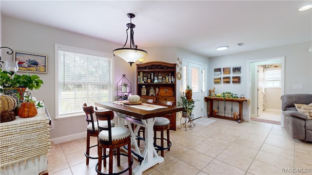 dining area featuring light tile patterned flooring