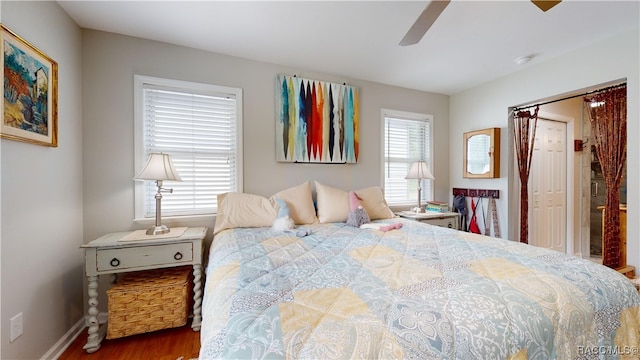 bedroom with wood-type flooring and ceiling fan