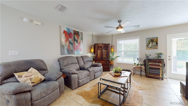 living room featuring light tile patterned floors and ceiling fan