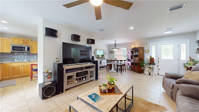 tiled living room featuring ceiling fan