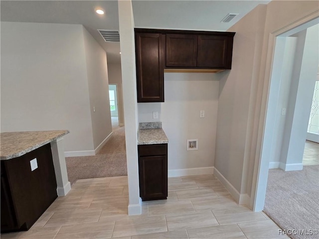 4953 N Triple Eagle Path, Beverly Hills, FL 34465 - kitchen featuring dark brown cabinets, light colored carpet, and recessed lighting