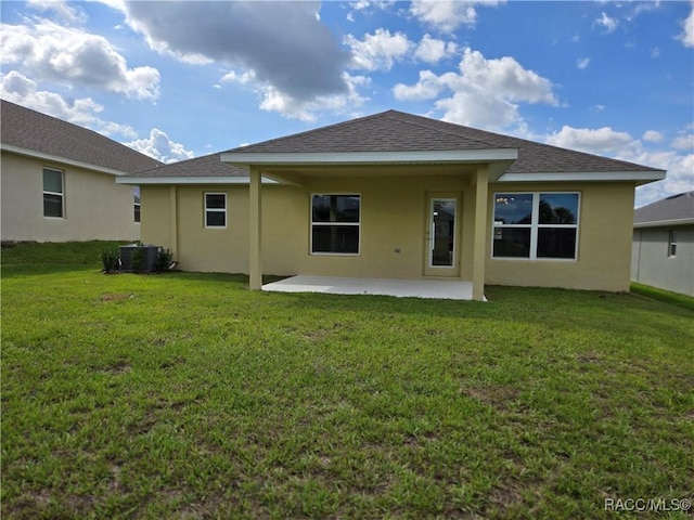 4953 N Triple Eagle Path, Beverly Hills, FL 34465 - back of house with a patio area, stucco siding, a lawn, and roof with shingles