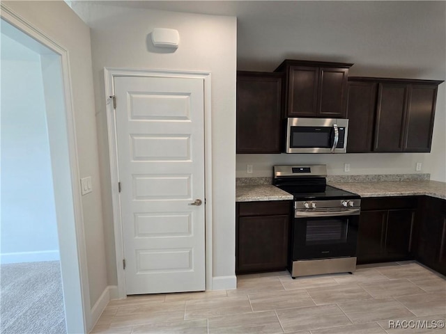 4953 N Triple Eagle Path, Beverly Hills, FL 34465 - kitchen featuring appliances with stainless steel finishes, dark brown cabinets, and light stone countertops