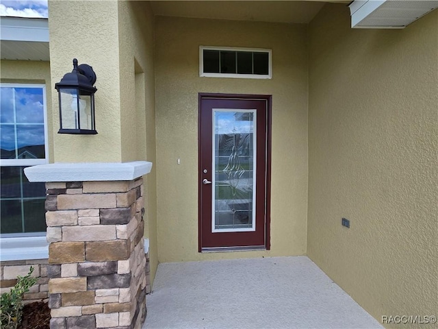 4953 N Triple Eagle Path, Beverly Hills, FL 34465 - view of exterior entry featuring stucco siding and stone siding