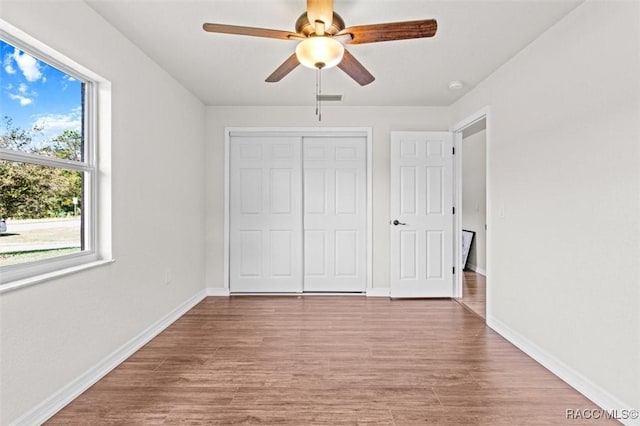 unfurnished bedroom with a closet, ceiling fan, and light hardwood / wood-style flooring