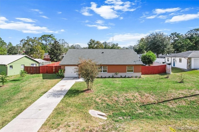 ranch-style house featuring a garage and a front lawn