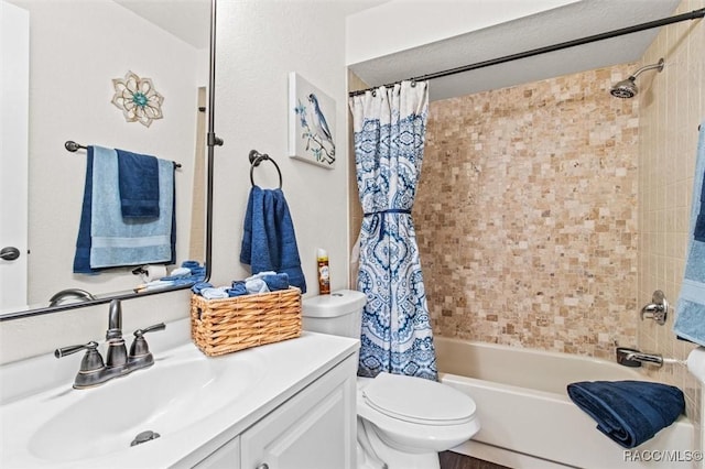 full bathroom with vanity, shower / tub combo with curtain, and toilet