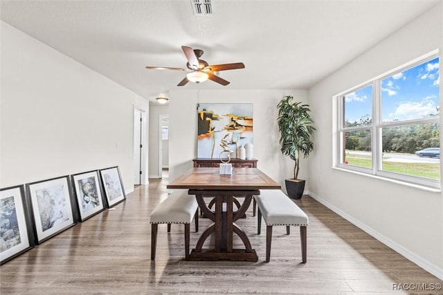 dining area with ceiling fan and hardwood / wood-style floors