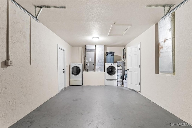 garage featuring separate washer and dryer and water heater