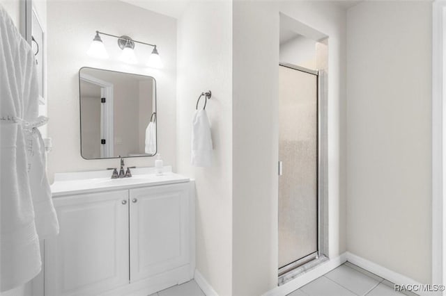 bathroom featuring an enclosed shower, vanity, and tile patterned flooring