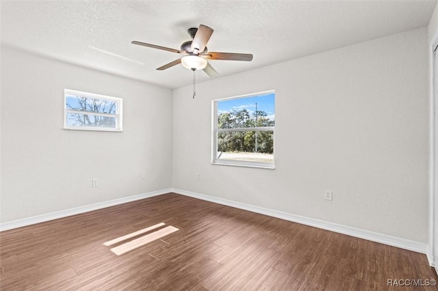 spare room with hardwood / wood-style flooring, ceiling fan, and a textured ceiling