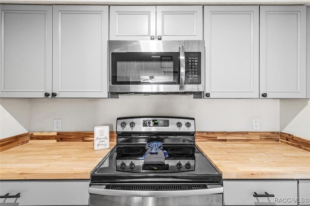 kitchen with stainless steel appliances and butcher block counters