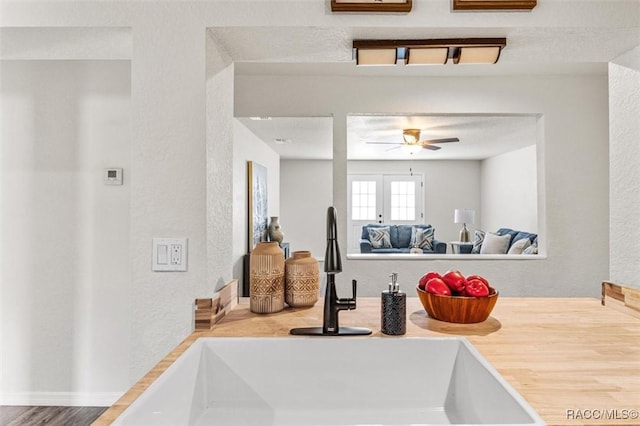 details with ceiling fan, sink, and a textured ceiling