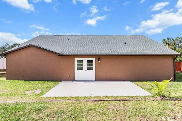 back of property with a patio area and a lawn