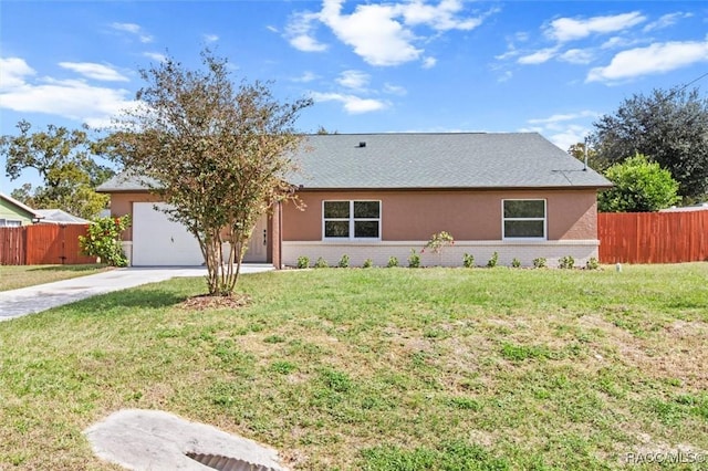 ranch-style home featuring a garage and a front lawn