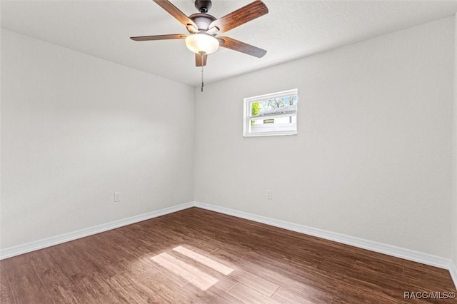 empty room with ceiling fan and wood-type flooring