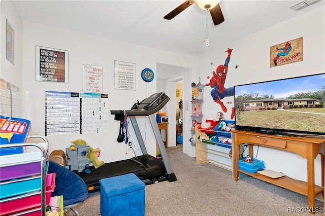 exercise room with carpet flooring and ceiling fan