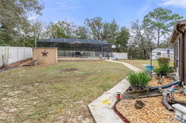 view of yard featuring glass enclosure, a swimming pool, and a shed