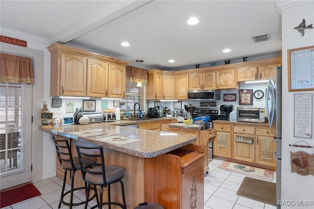 kitchen with kitchen peninsula, appliances with stainless steel finishes, light tile patterned floors, a breakfast bar, and ornamental molding